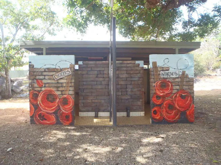 An Anzac mural is painted on a public toilet block.