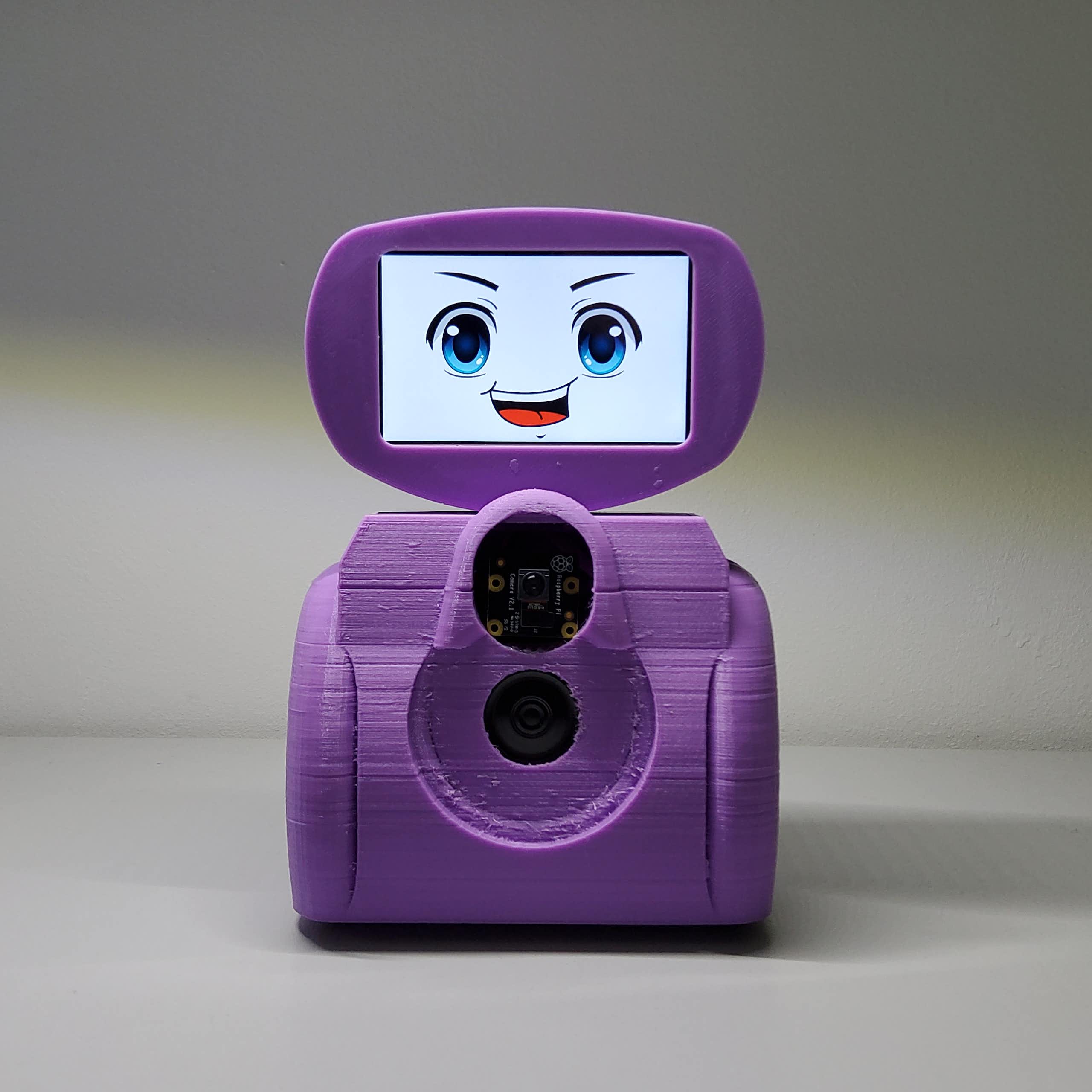 Pequeño robot de color morado con un interfaz de pantalla con ojos y boca.