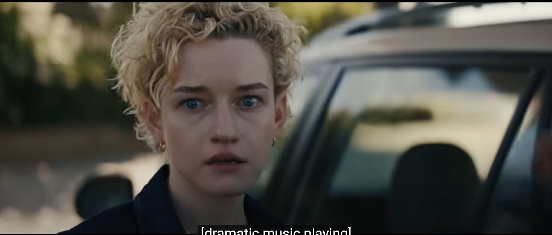 A close up image of a woman's face with fearful and stunned eyes. 