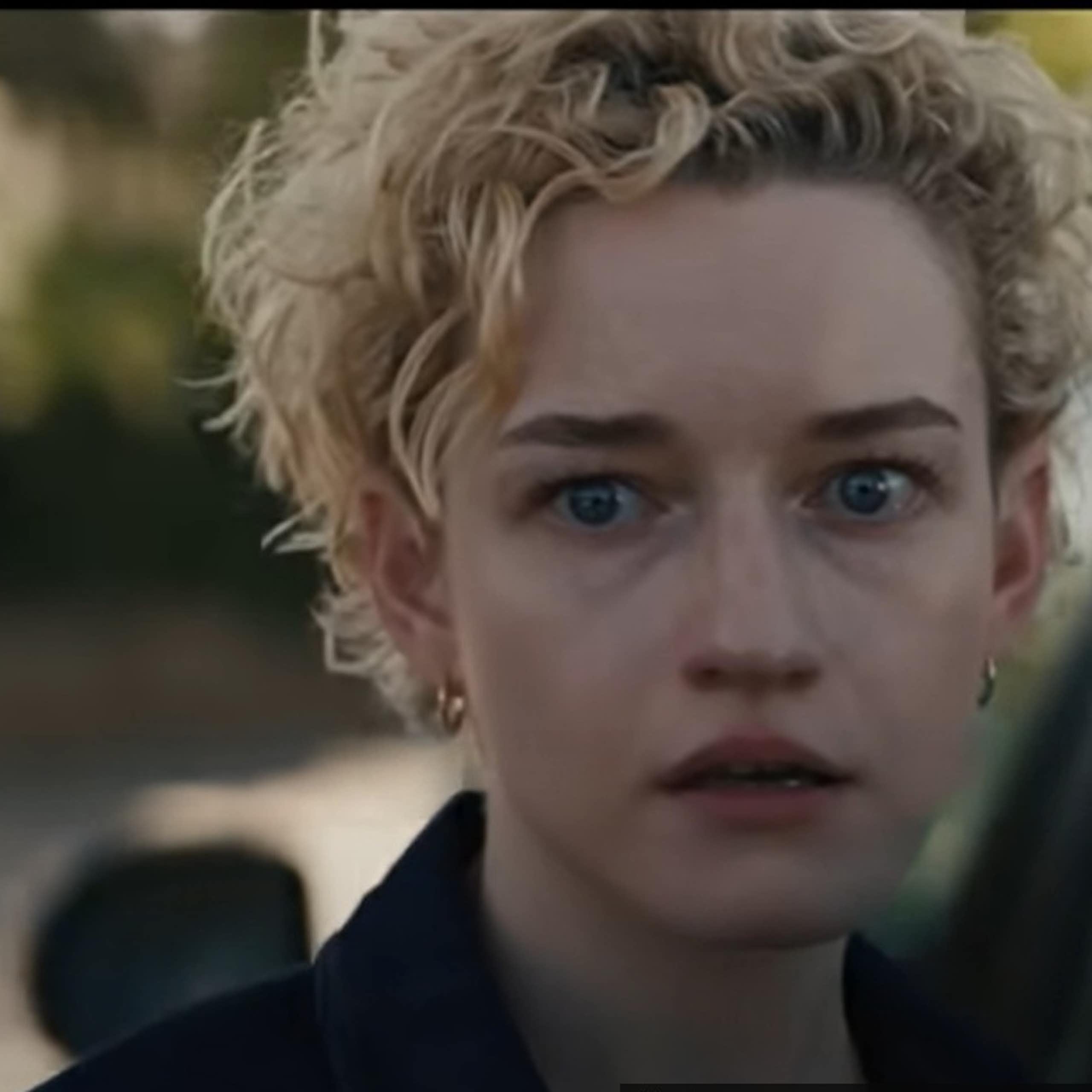 A close up image of a woman's face with fearful and stunned eyes.