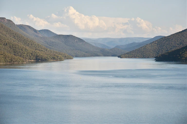 reservoir with tree covered hills