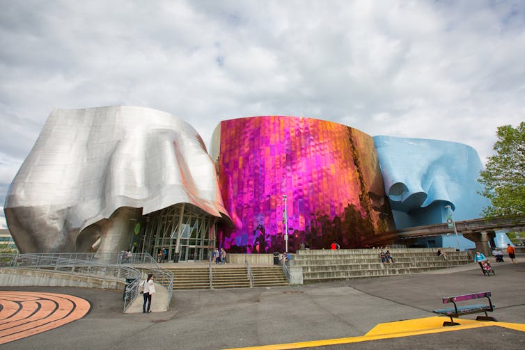 A silver, pink and blue building.