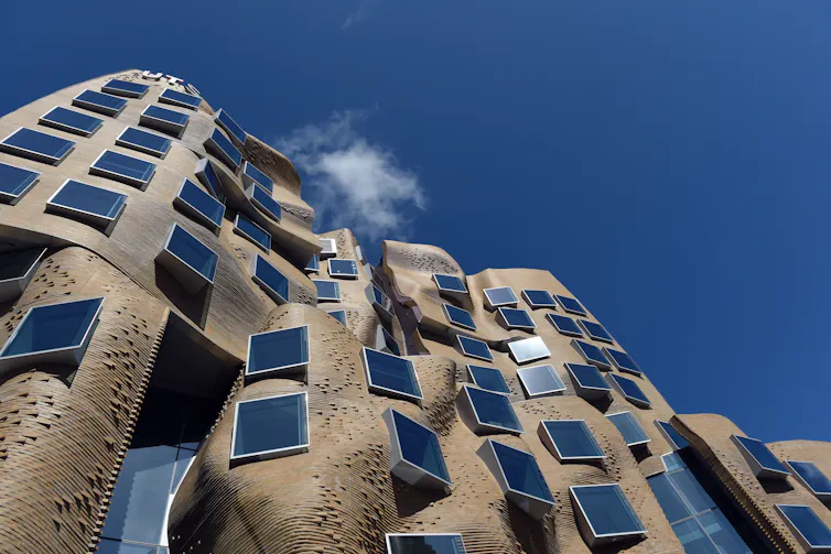 A building of undulating brown bricks.