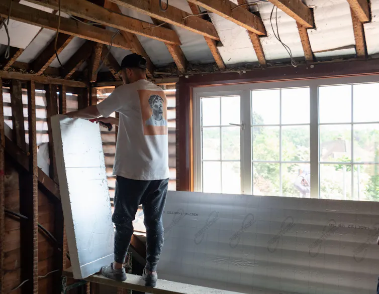 Man in attic with boards