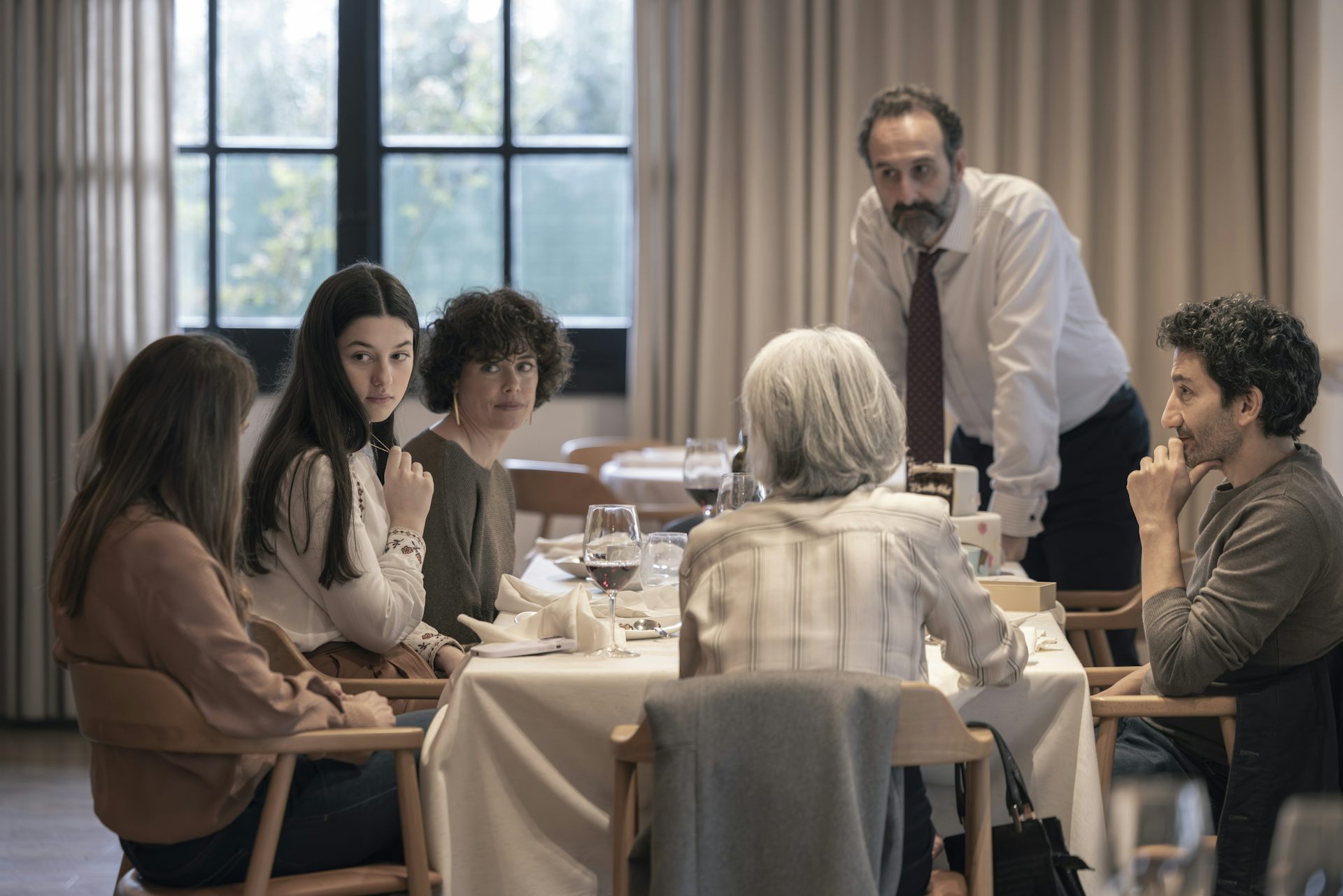 The family is sitting at the table.