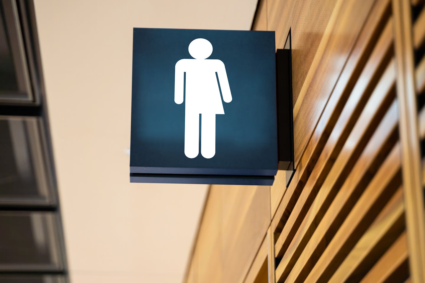 Gender neutral bathroom sign attached to wall