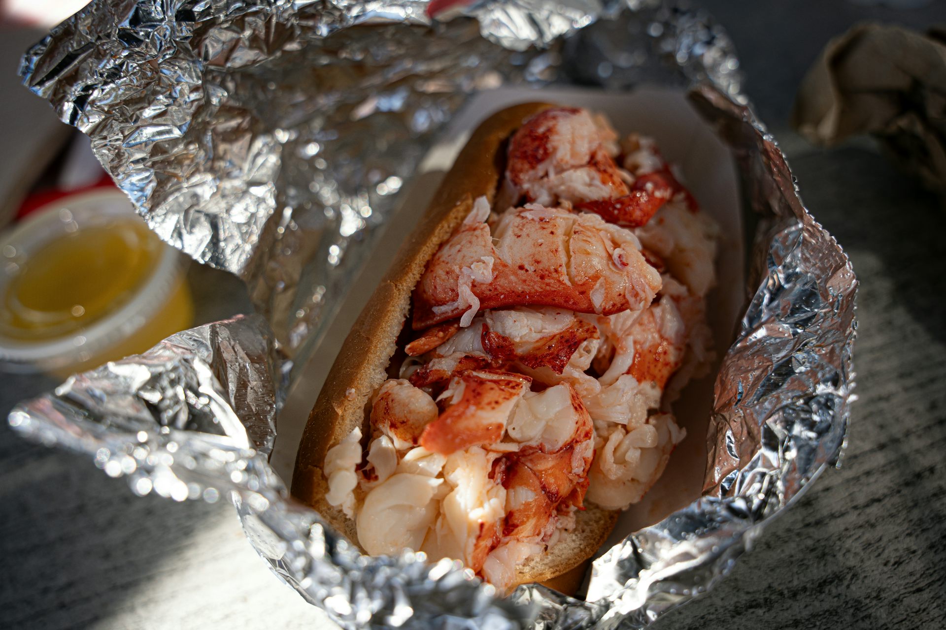 A sandwich stuffed with pieces of lobster.