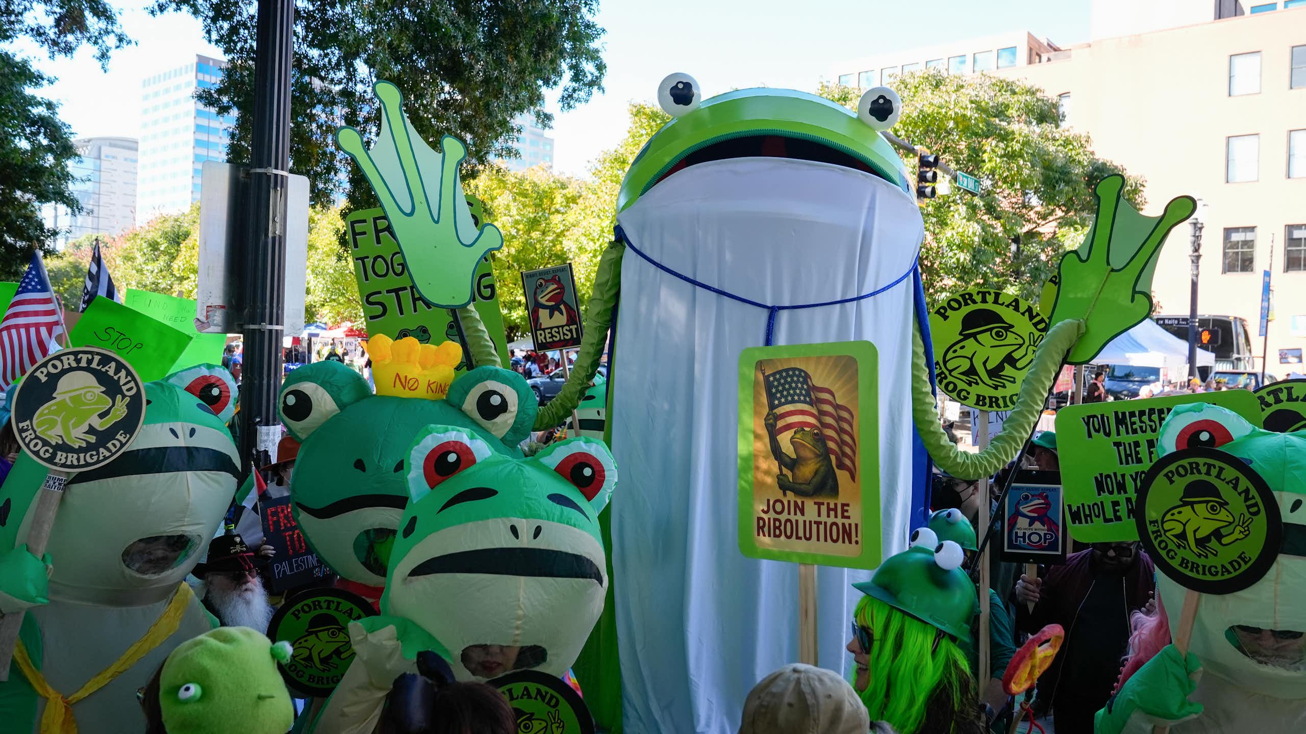 People in frog costumes gather at a 'No Kings' protest in Portland.