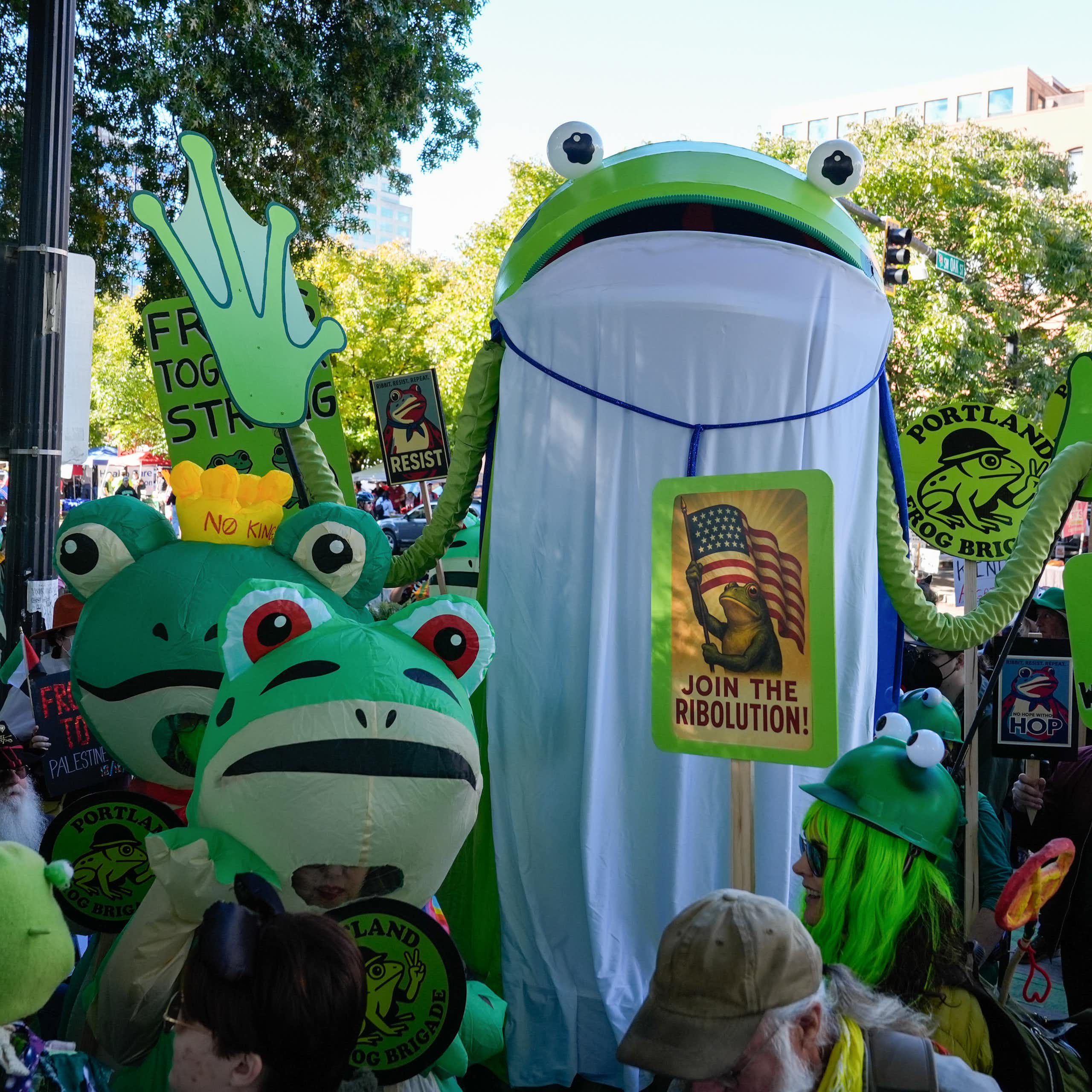 People in frog costumes gather at a 'No Kings' protest in Portland.
