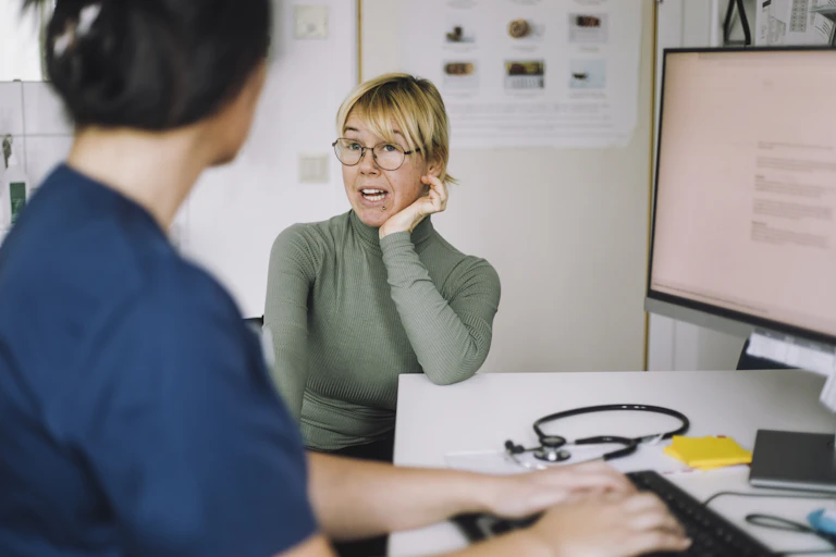 Patient talks to their GP, who types notes
