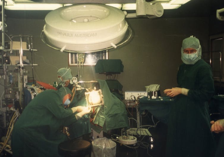 Stem cellular treatment: a brand new technology in mind regeneration after stroke? 1 Doctors and nurses dressed in gowns and masks prepare a patient in the operating room.