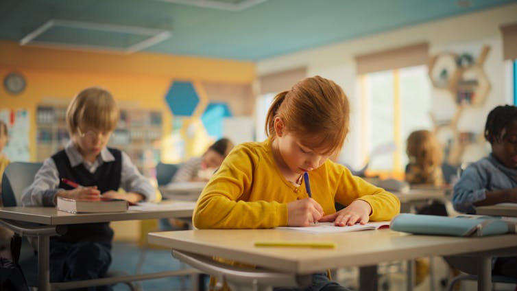 Children in classroom taking test