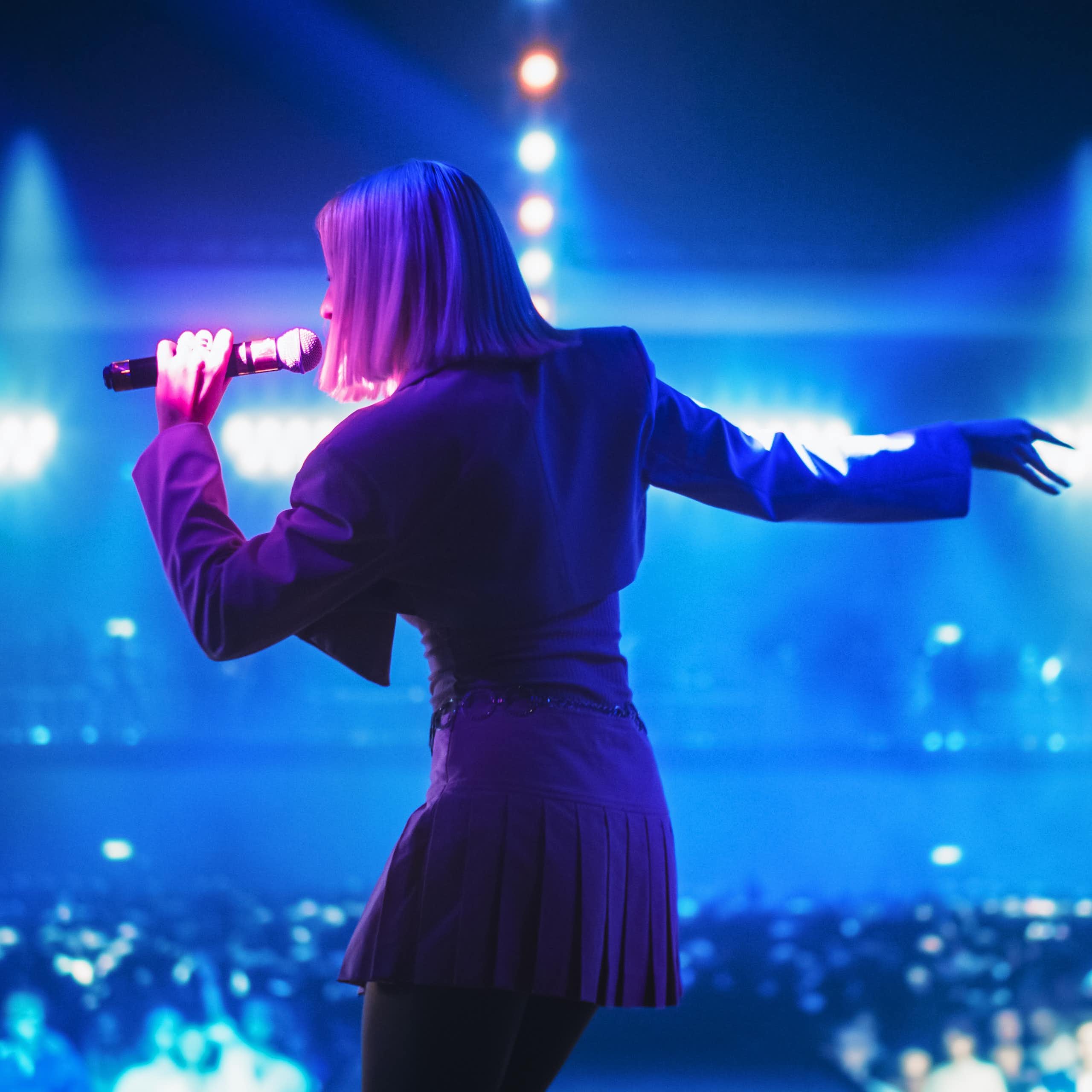 A woman singing on a stage