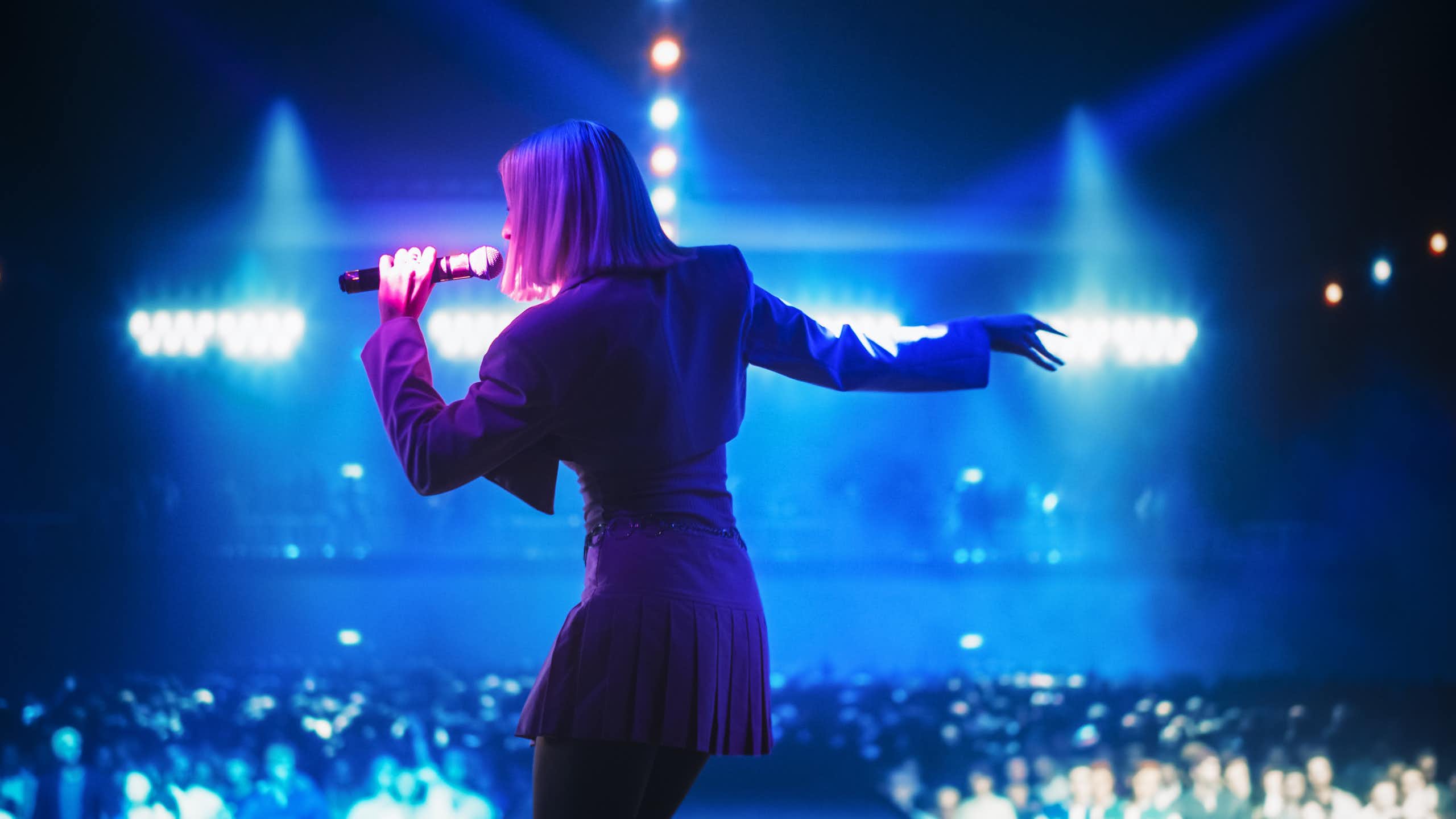 A woman singing on a stage