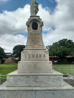 A tiered monument says 'Tshaka,' as well as a longer inscription in smaller letters.
