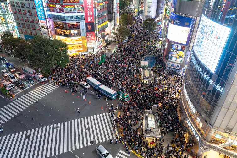 A large crowd of people gathered at the Shibuya 'scramble' crossing.