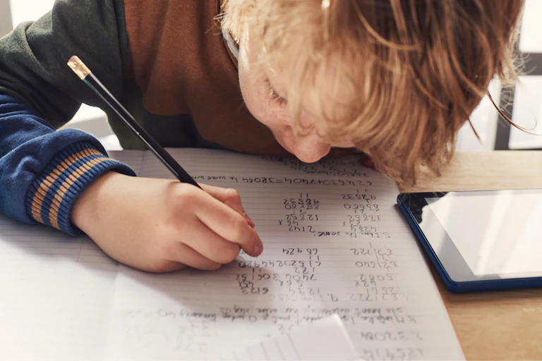 A child writing maths exercises