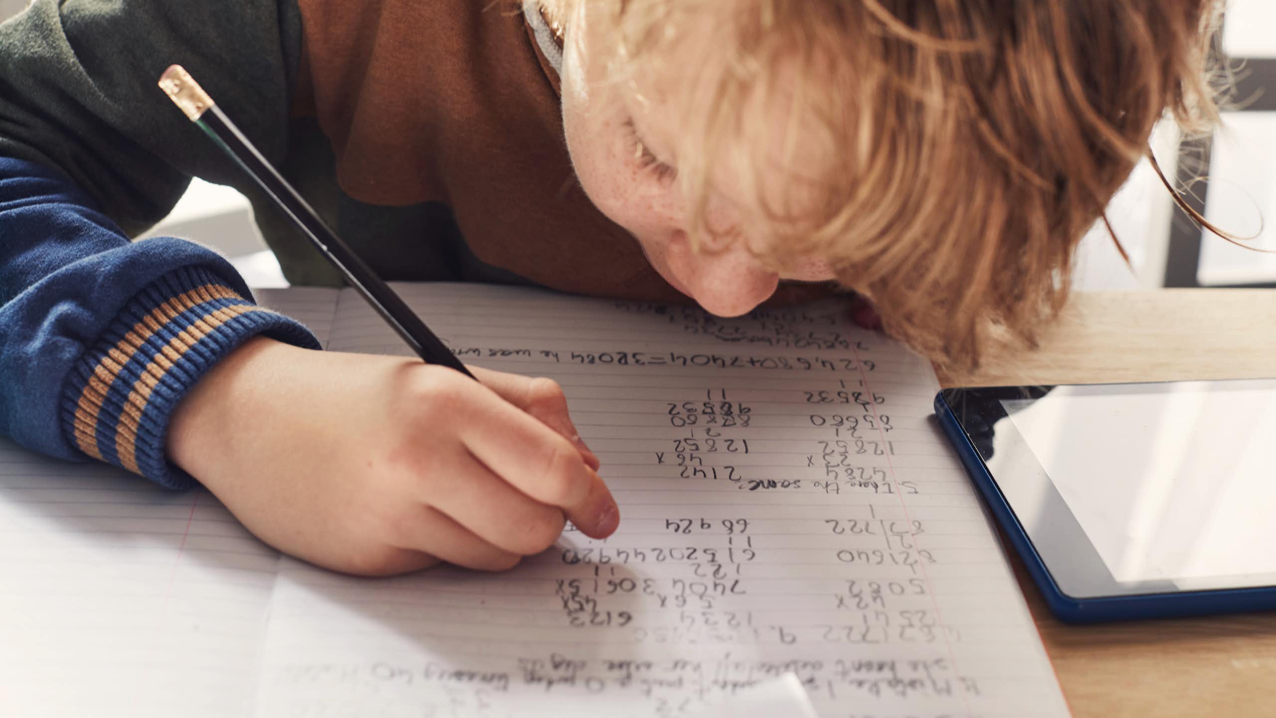 A child writing maths exercises