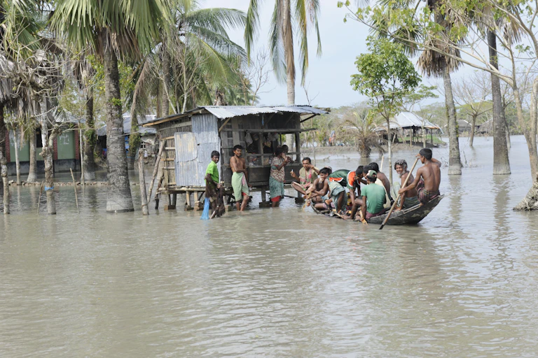 boat with people on flooded waters in Bangladesh
