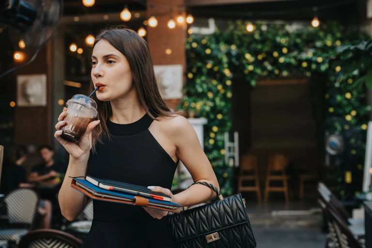 A woman drinking a coffee.