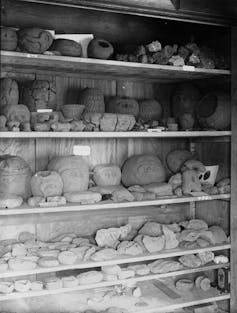 shelves with various clay vessels and shards piled on them