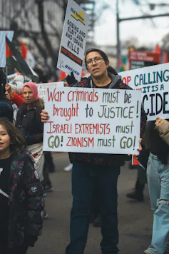A protestor holding up an anti-zionism sign.