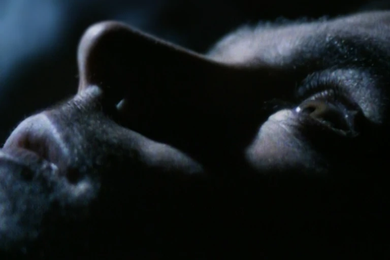 Close up of man's face in darkness taken from tv show