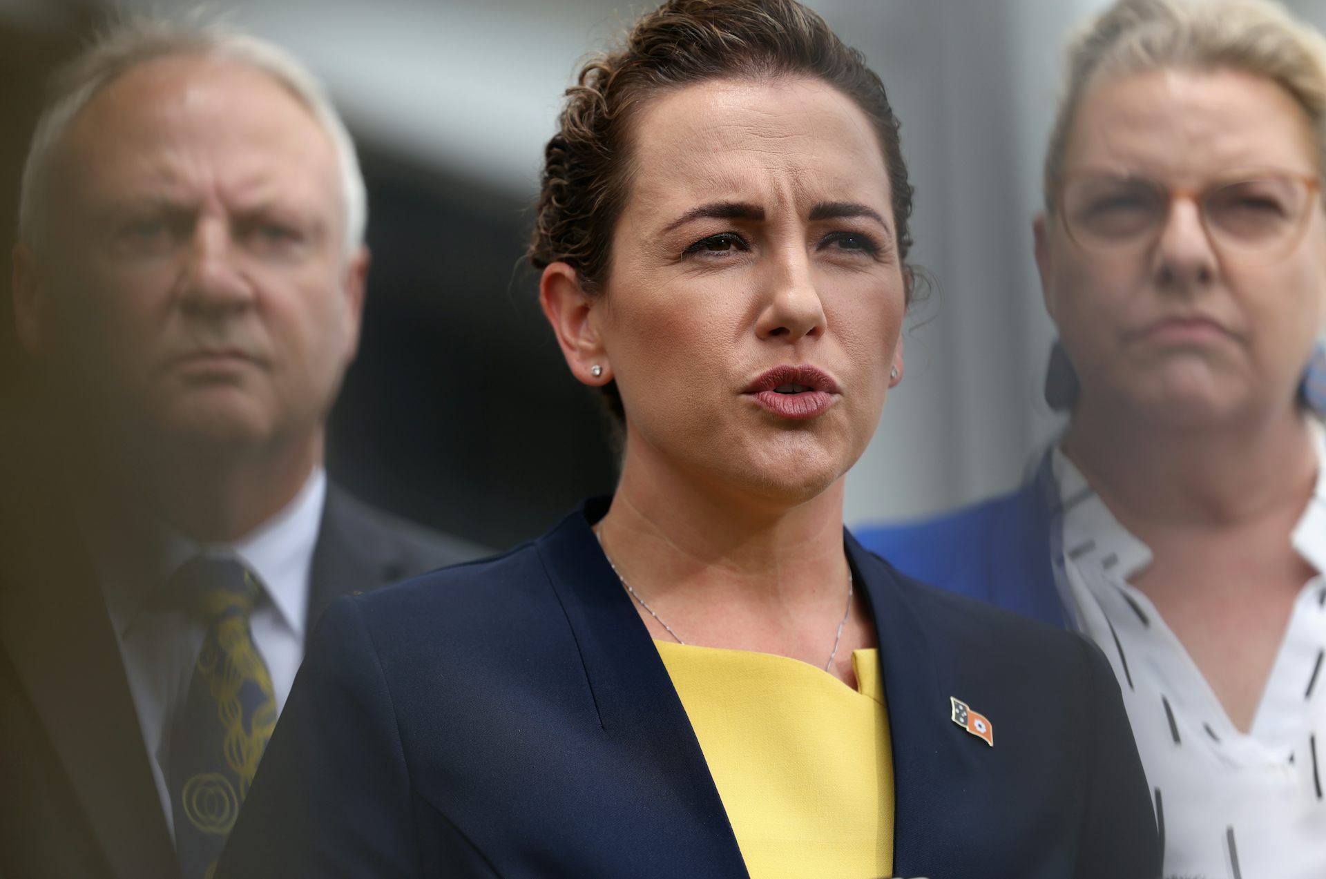 NT Chief Minister Lia Finocchiaro wears a yellow top and a blue jacket while addressing the media
