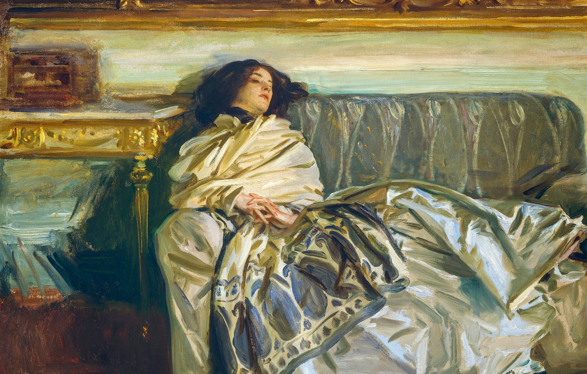 Woman sleeping on sofa wearing silk dress.