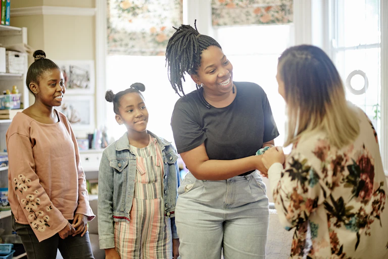 Parent and children meeting teacher