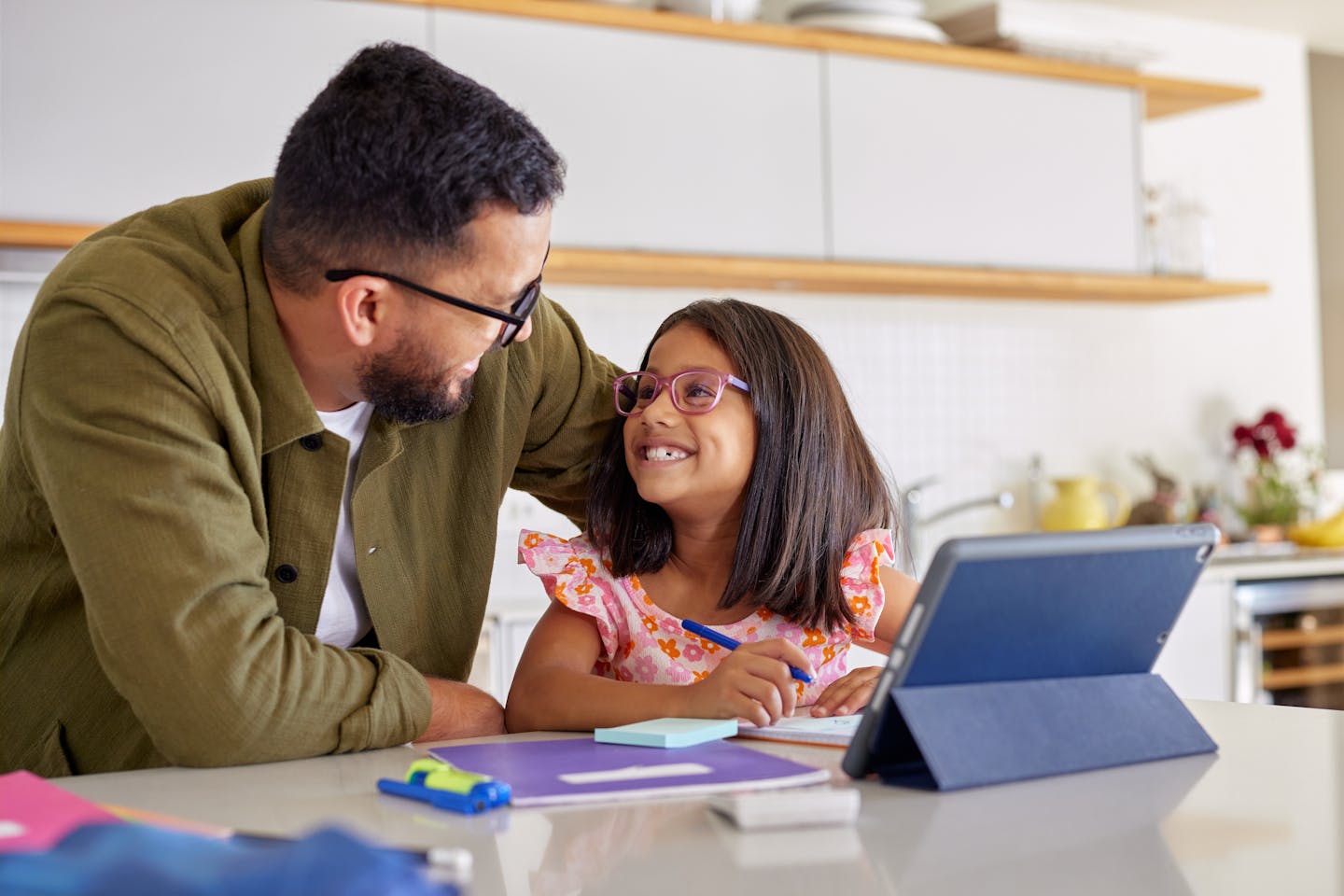 Father helping girl with homework