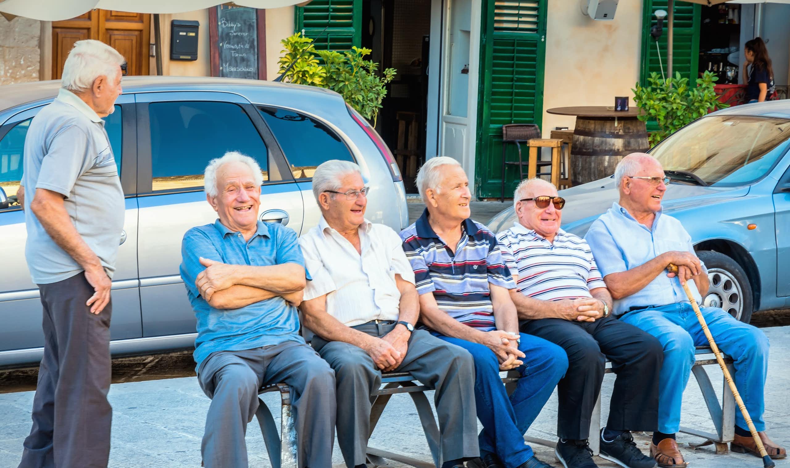 Group of old men sitting on a bench