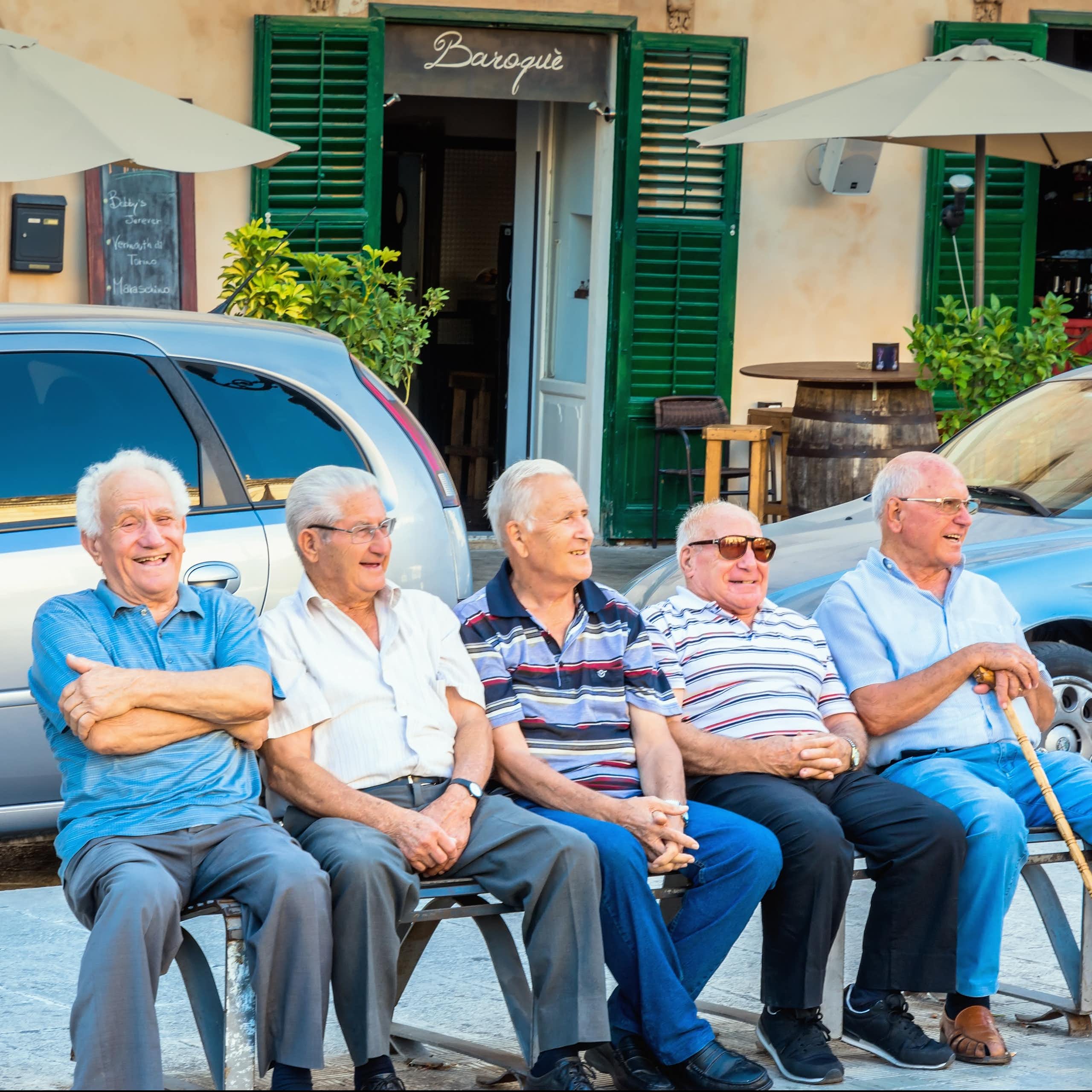 Group of old men sitting on a bench