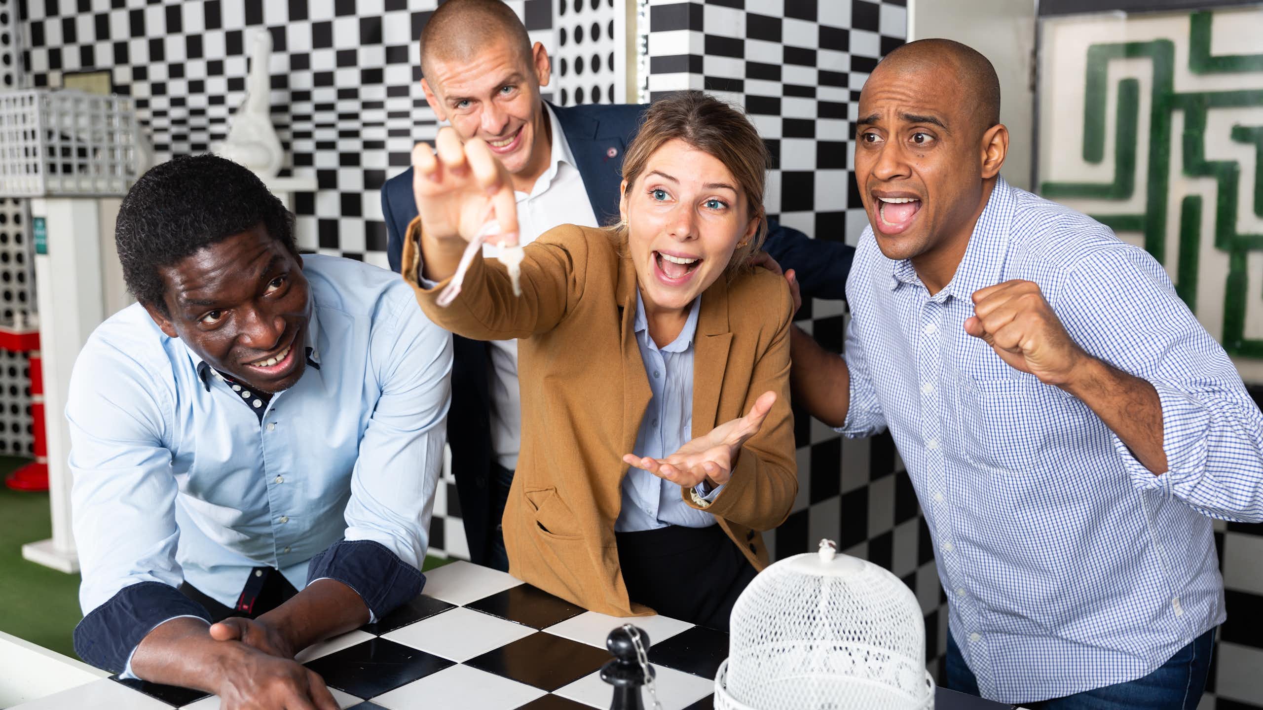 Young adult people trying to solve puzzles to get out of escape room