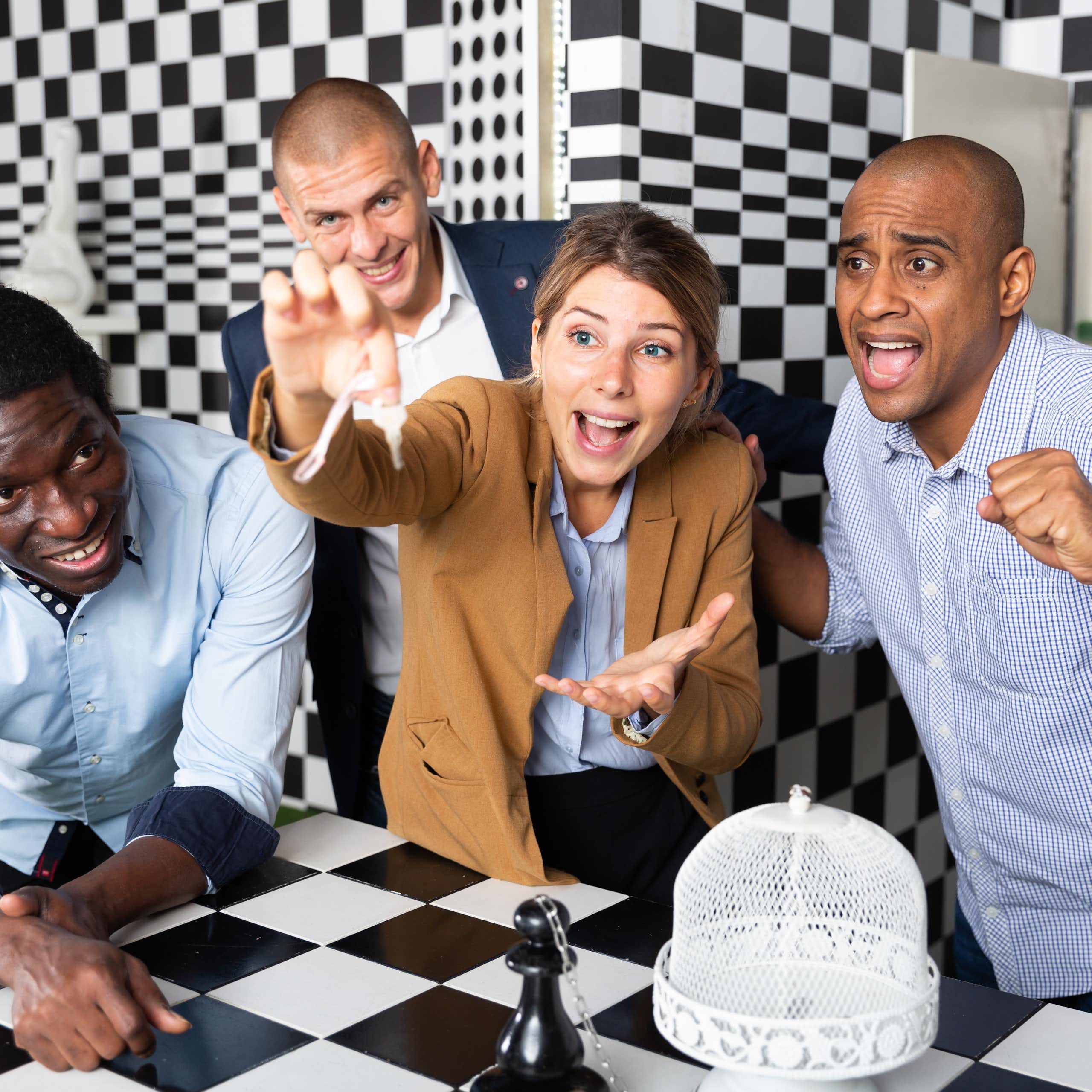 Young adult people trying to solve puzzles to get out of escape room