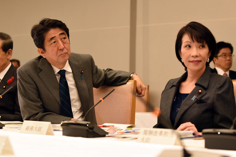 Shinzo Abe sat at a table with Sanae Takaichi.