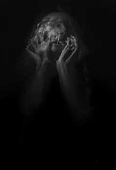 A female figure screaming.