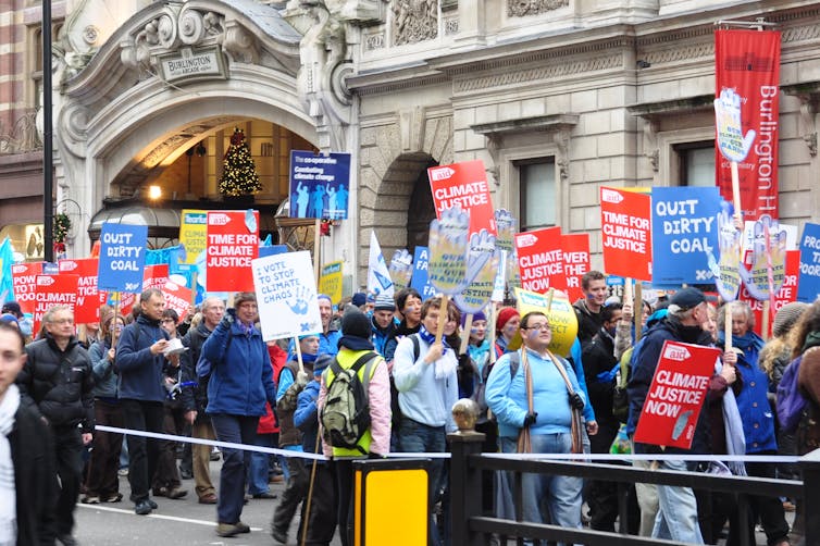 A climate protest of people carrying signs