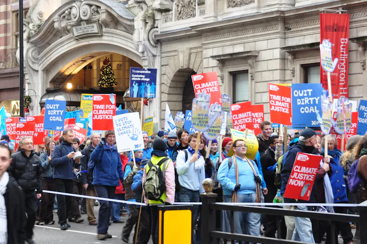 A climate protest of people carrying signs