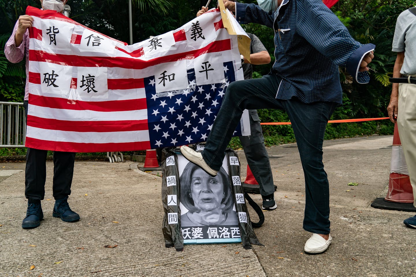 A person steps on an image of a woman's face.