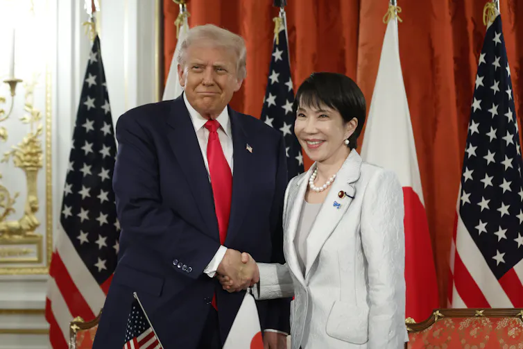 Donald Trump and Sanae Takaichi pose for photographs.