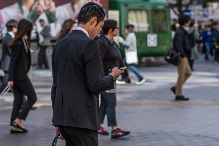 Japanese office workers walking through Tokyo.