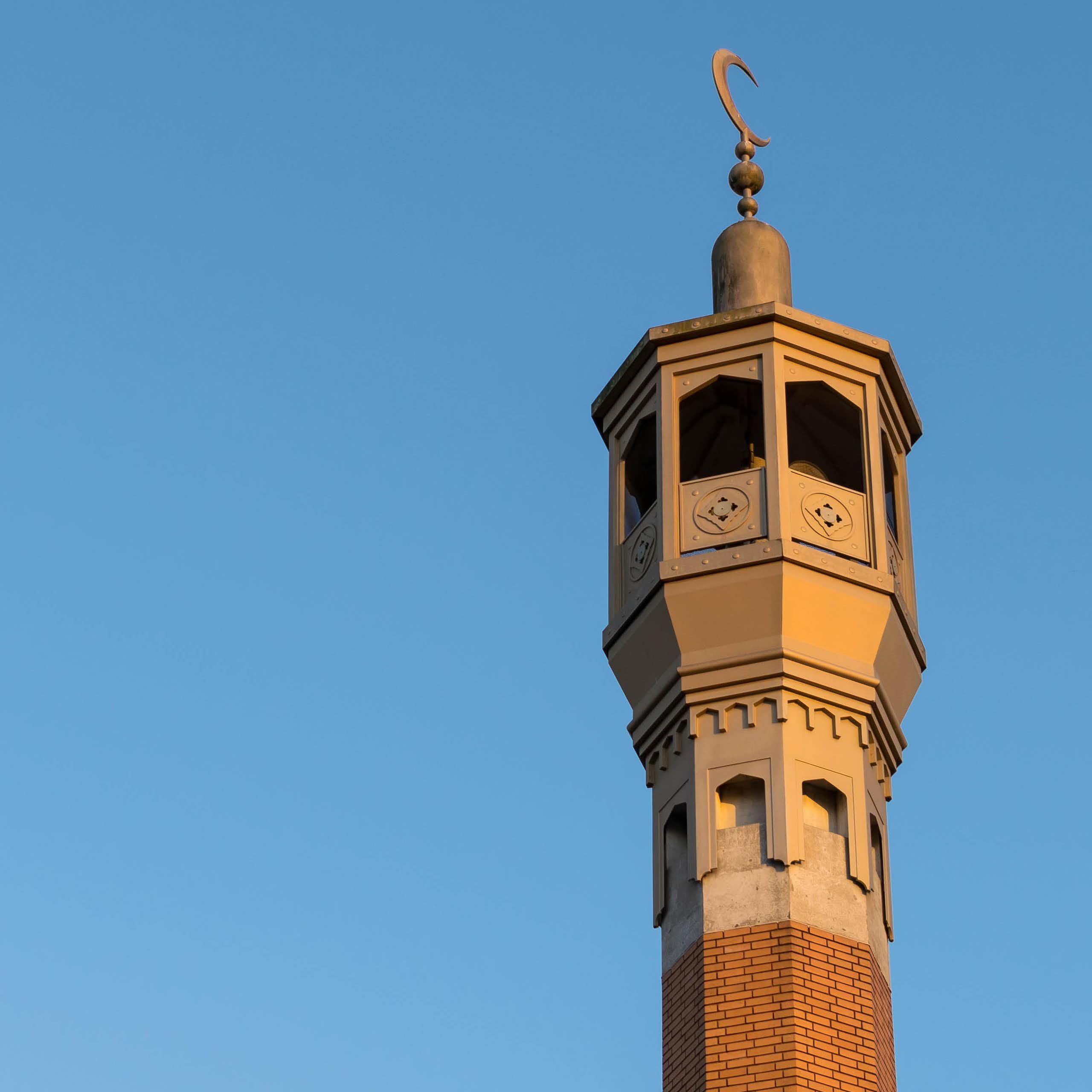 A mosque minaret against a blue sky