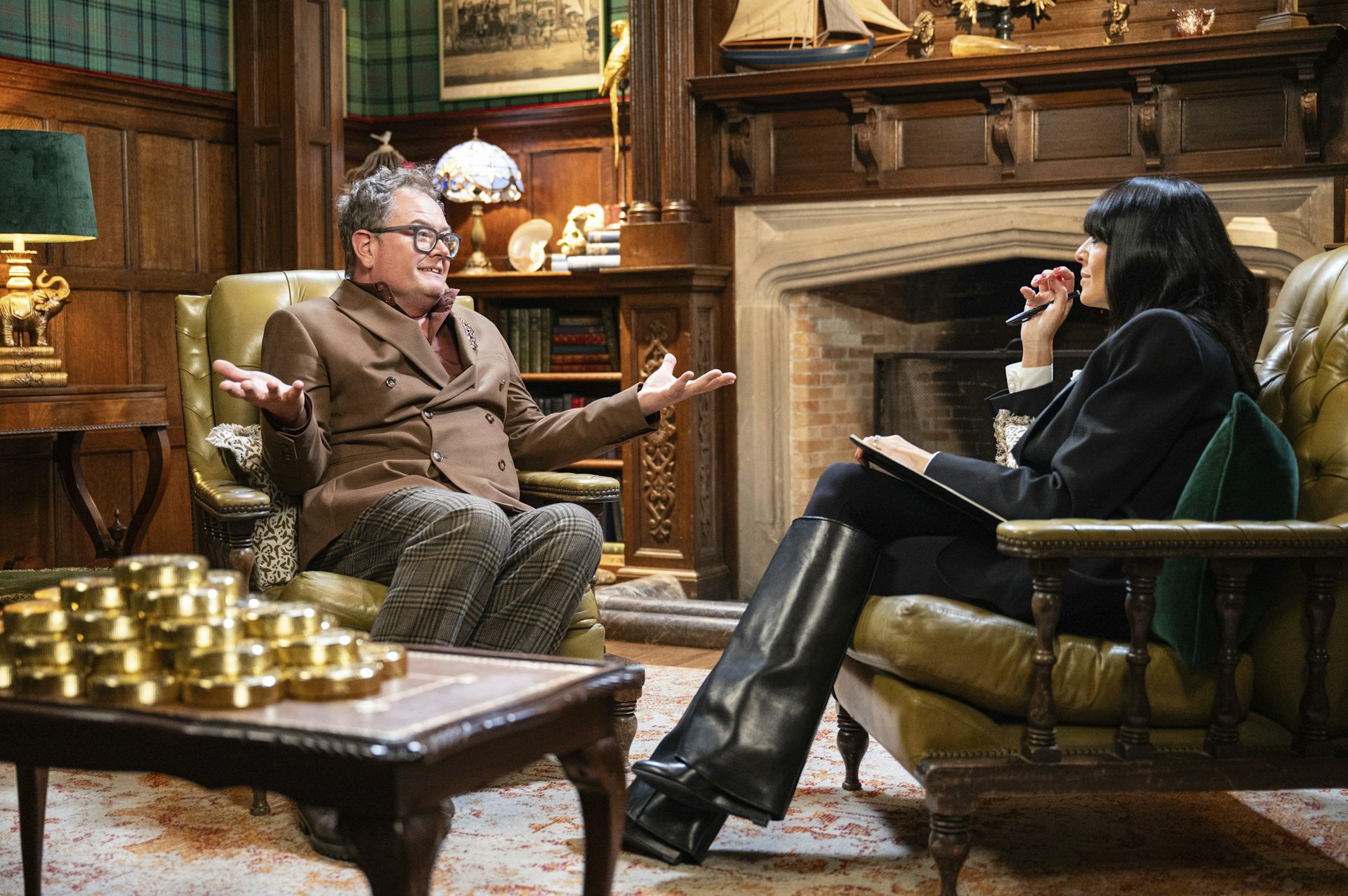 Alan Carr speaks to Claudia Winkelman on set of The Traitors.