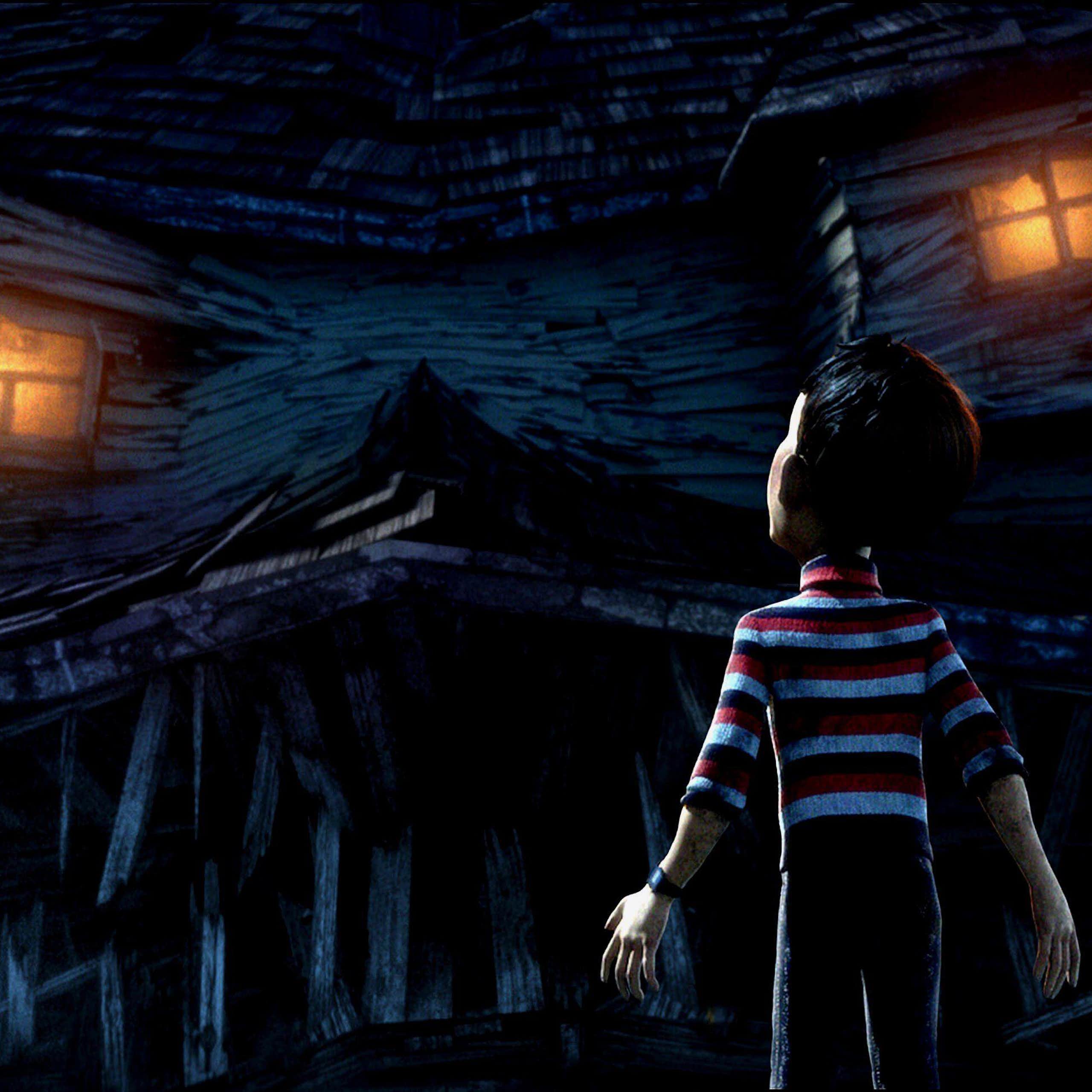 A boy stands in front of a house that has come alive.