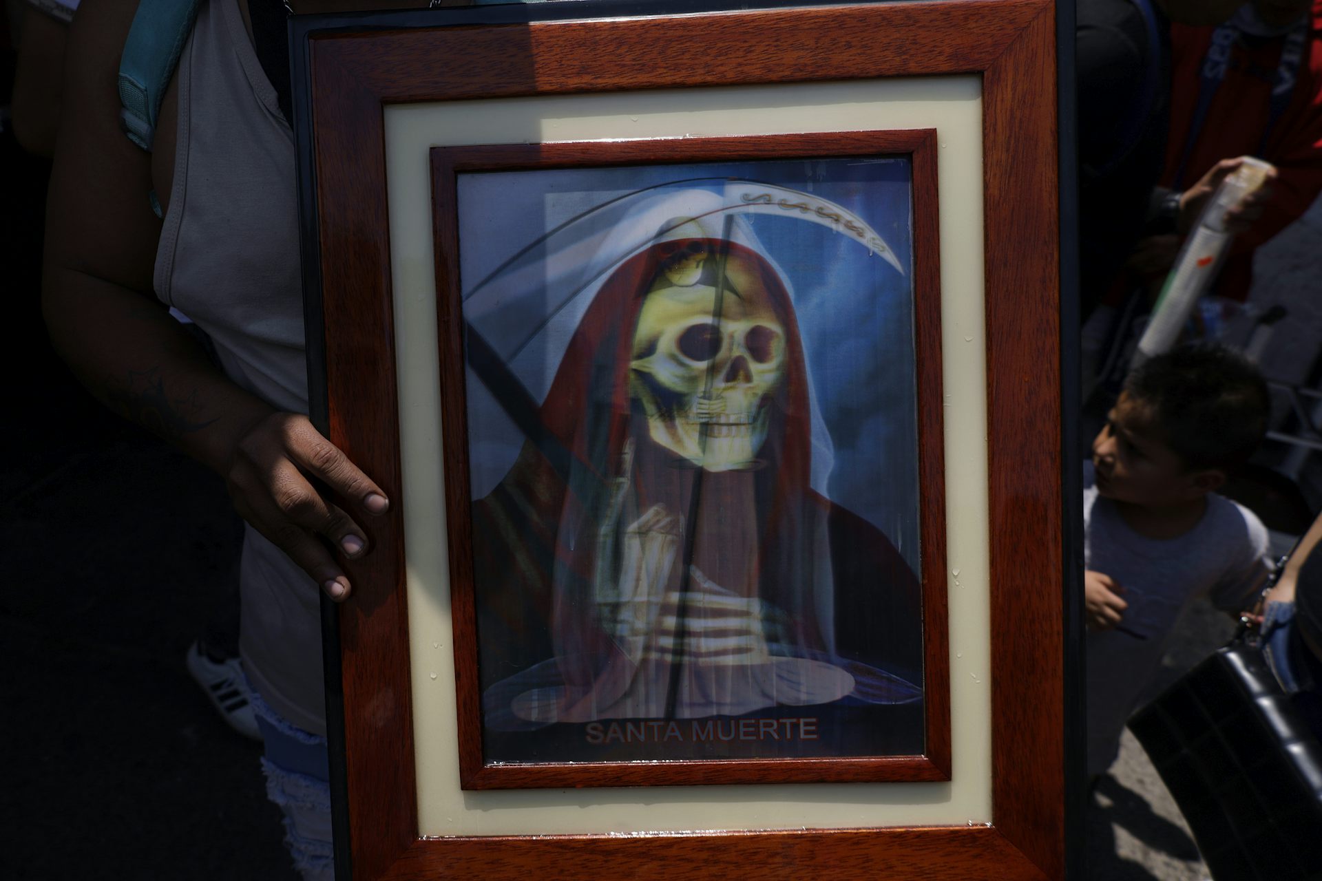A person holding a picture of a religious icon.