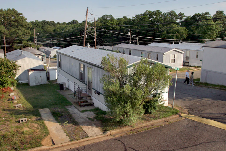 A row of white, narrow manufactured homes.