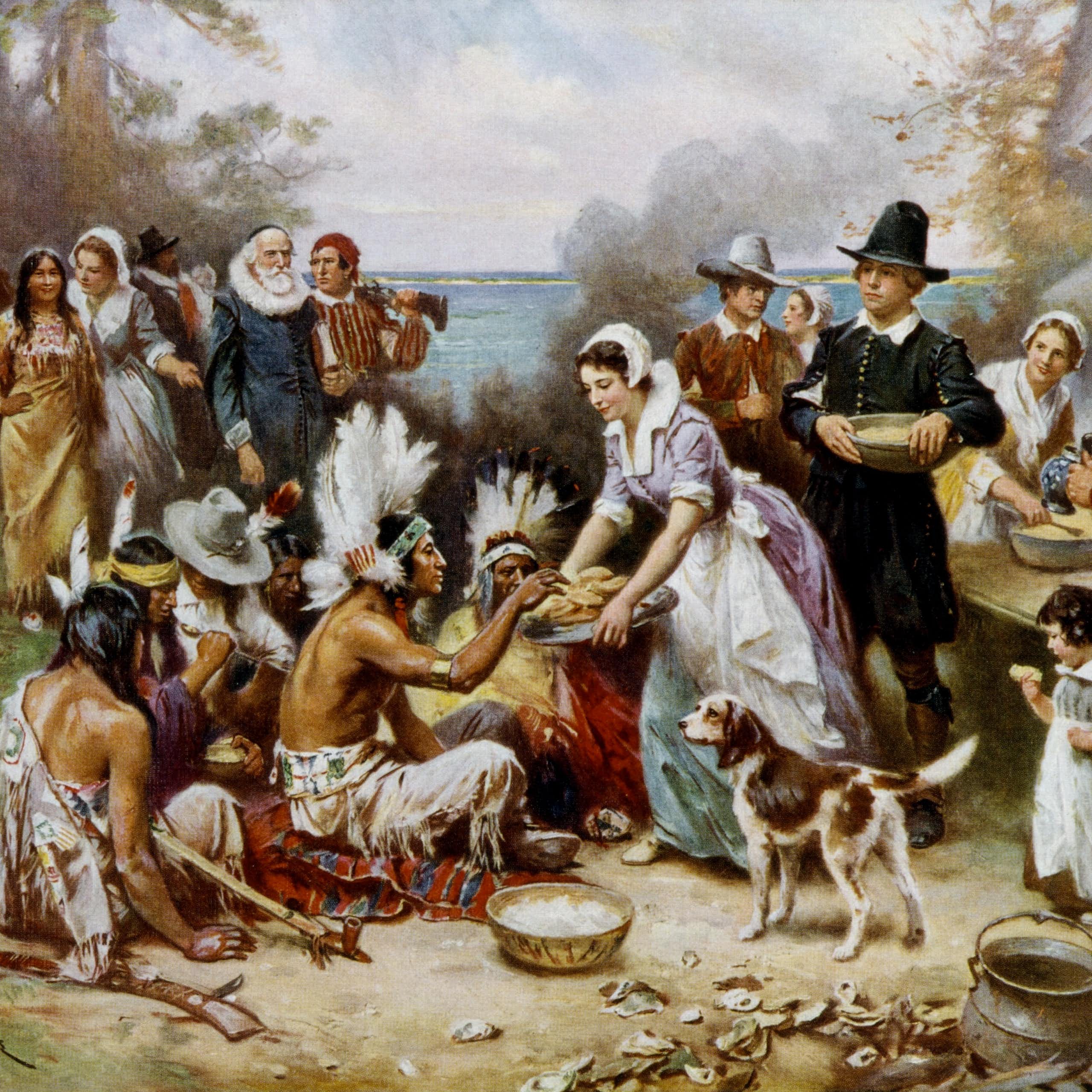 A painting shows Pilgrims and Native Americans chatting as they prepare a meal outside.