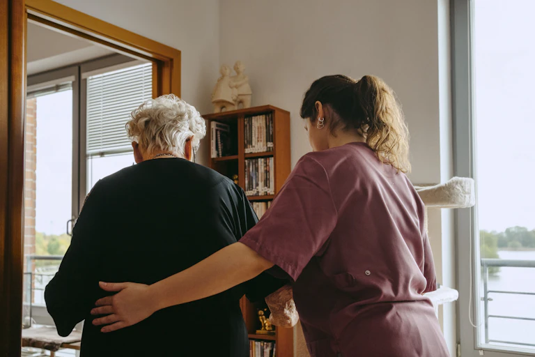 Aged care worker supports an older person in their home