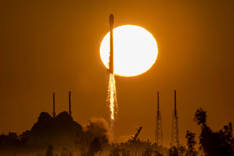 A rocket launch with the Sun in the background.